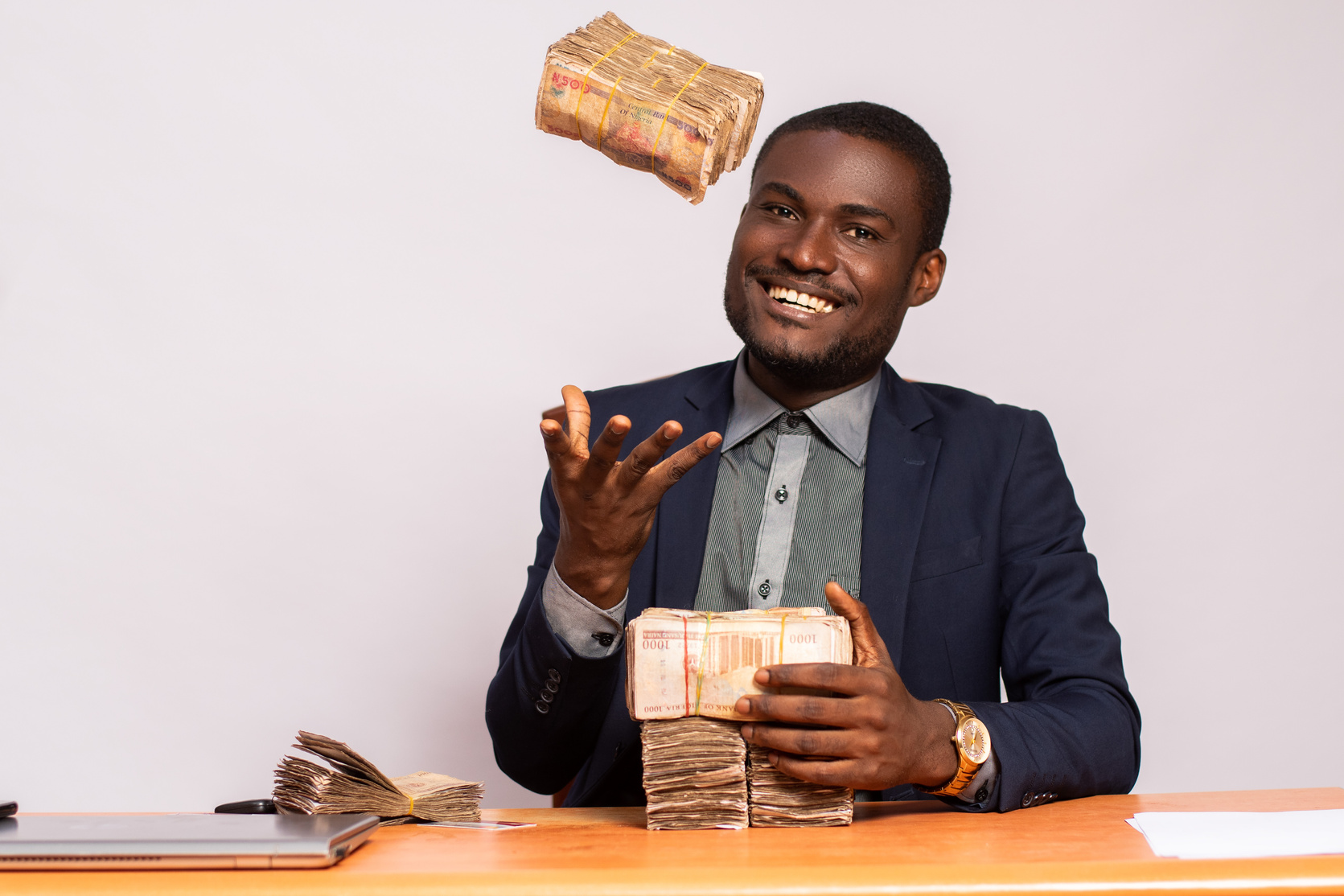 happy african businessman with lots of money